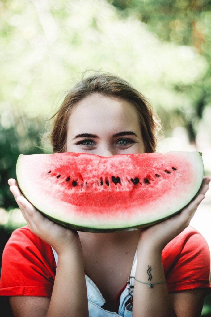 Woman holding up watermelon slice